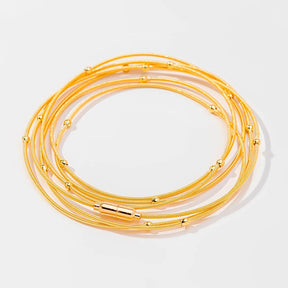 Pulseira corda de violão com bolinhas banhada a ouro 18k